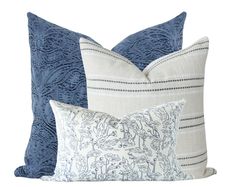 three pillows with blue and white designs on them