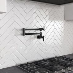 a stove top oven sitting inside of a kitchen next to a wall mounted range hood