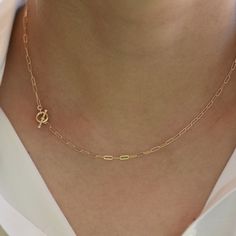 "14K Toggle Necklace, Gold Paper Clip Chain, Delicate Necklace Gold Choker. 14K gold Long Link Chain This necklace can be worn by itself or with other necklaces. *The chain, toggle clasp and all components are 14K solid yellow gold (If you order a 16\" necklace, it will be a toggle clasp plus chain will be 16\".) *The toggle clasp is about 3/8\" The model in the picture wears a 16\" necklace. Please read our policies before you place your order. https://www.etsy.com/shop/SashJewelry/policy?ref=s Minimalist Yellow Gold Toggle Necklace For Everyday, Gold Minimalist Toggle Necklace With Paperclip Chain, Minimalist Gold Toggle Necklace With Paperclip Chain, Gold Minimalist Toggle Necklace With Cable Chain, Minimalist Oval Link Toggle Necklace With Cable Chain, Minimalist Toggle Necklace With Oval Link Cable Chain, Elegant Yellow Gold Chain Link Toggle Necklace, Classic Yellow Gold Link Toggle Necklace, Gold Dainty Toggle Necklace For Everyday