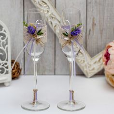 two wine glasses with purple flowers on them