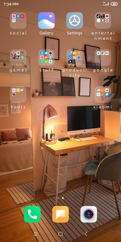 a computer desk sitting in front of a window with lots of pictures on the wall