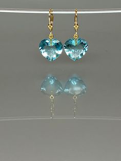 Gorgeous sparkly aquamarine heart earrings. The Faceted heart shape drops are flawless and have a beautiful clear sky blue color. The drops attached to secure 14k gold-filled lever backs. The earrings are elegant and have a lux look. The earrings are elegant and perfect to go with any outfit. A truly gorgeous pair of earrings. *AAA+ Faceted sky blue aquamarine hearts *The dimension of stones is about: 15mm *Metal: 14k gold filled *Earrings drop length (ear wires including the stones): 32 mm/ 1.3 Elegant Heart-shaped Gemstone Earrings, Elegant Blue Earrings For Valentine's Day, Blue Pierced Heart Drop Earrings, Elegant Gemstone Heart Cut Earrings, Blue Pierced Heart Earrings, Elegant Heart Cut Gemstone Earrings, Blue Heart-cut Heart Earrings For Anniversary, Blue Earrings For Anniversary On Valentine's Day, Blue Heart Cut Earrings For Anniversary