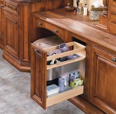 an open drawer in the middle of a kitchen