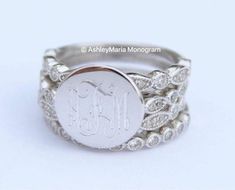 a monogrammed ring with the initials on it and an oval button in the middle