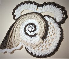 three crocheted placemats on top of each other, one with a spiral design