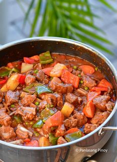 a large pot filled with meat and vegetables