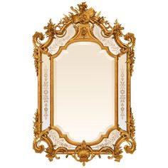 an ornate gold framed mirror on a white background