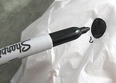 a black and white pen sitting on top of a paper bag