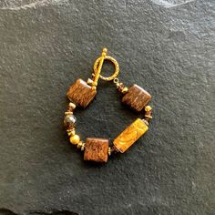 A bracelet made of Bronzite squares with gold accent bead and toggle clasp Create Website, Gold Accent, Toggle Clasp, Gold Accents, Beaded Bracelets, Pendant Necklace, Drop Earrings, Bracelet, Beads