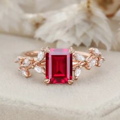 Our 14K Solid Gold Nature-Inspired Emerald Cut Ruby Engagement Ring is a symbol of everlasting love. The natural inspiration behind the design, coupled with the brilliance of the lab-grown ruby, makes this ring truly beautiful. Radiant Cut Ruby Promise Ring With Prong Setting, Ruby Ring With Radiant Cut Center Stone, Elegant Ruby Ring With Radiant Cut, Rose Gold Ruby Ring In Fine Jewelry Style, Rose Gold Ruby Ring With Lab-created Gemstone, Radiant Cut Red Ruby Ring For Wedding, Exquisite Red Promise Rings, Red Radiant Cut Ring With Center Stone, Elegant Red Moissanite Ruby Ring