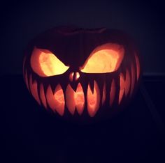 a carved pumpkin with glowing eyes on it