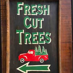 a sign that says fresh cut trees and an arrow pointing to the right with a red truck on it