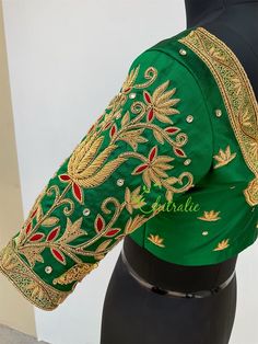 This is made to order/ custom made according to your requirements. Fabric - Pure soft silk Color - Dark green Princess Cut Padded Deep U shape neck front and back Front Hook Closure Half Sleeve Cotton lining An epitome of beauty, grace and elegance. Luxury bridal blouse is designed by our designer Lekha Meera. Beautiful zardozi work heavy bridal blouse. The lotus designs on the blouse gives it an elegant and unique look with it purity. It's handcrafted by trained artisans. We made it with love a Green Handwork Blouse For Wedding, Wedding Green Blouse Piece With Motifs, Green Fitted Saree For Ceremonial Occasions, Fitted Green Saree For Ceremonial Occasions, Green Art Silk Blouse For Wedding, Green Handwork Saree For Wedding, Green Wedding Blouse With Dori Work, Green Silk Blouse For Reception, Green Blouse With Cutdana For Traditional Ceremonies