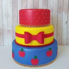 three tiered cake decorated with apples and bows