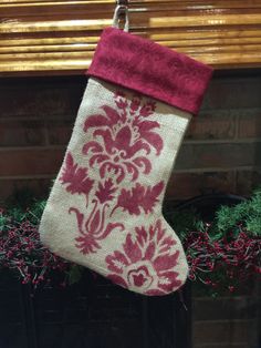 a red and white stocking hanging from a fireplace