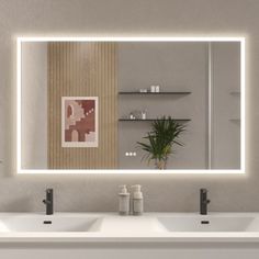 a bathroom with two sinks and a large mirror over it's wall mounted faucet