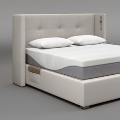 an image of a bed with mattress and headboard in the middle on grey background