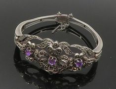 "925 Silver - Vintage Amethyst & Marcasite Victorian Bangle Bracelet - BT6646  925 Silver - Vintage Amethyst & Marcasite Victorian Bangle Bracelet - BT6646  Jewelry Type:         Bracelet   Metal Type:            925 Silver  Metal Size:             6.5\" Length  1\" Height   Stone Type:            Amethyst & Marcasite   Condition:              N/A  Jewelry Weight:     32.6 Grams  PLEASE NOTE: THIS ITEM IS PRE-OWNED. ALTHOUGH MOST ITEMS ARE IN VERY GOOD CONDITION, SOME MAY NEED CLEANING AND/OR MINOR REPAIRS. WE MAKE A VERY STRONG EFFORT TO UPLOAD CLEAR PICTURES. PLEASE INSPECT ALL PICTURES AND ASK ALL QUESTIONS YOU MAY HAVE PRIOR TO MAKING A PURCHASE. NOT ALL STONES ARE GENUINE, SOME ARE ENHANCED OR CREATED." Antique Silver Gemstone Bracelet, Victorian Silver Multi-stone Jewelry, Silver Victorian Multi-stone Jewelry, Bracelet Metal, Metal Bracelets, Bangle Bracelet, Beautiful Rings, Types Of Metal, Metallic Silver