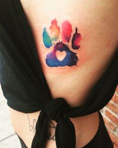 a woman's stomach with a colorful paw print on the side of her belly