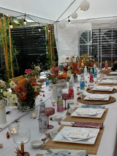 a long table is set up with flowers and cards