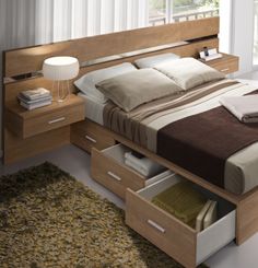 a bed with two drawers underneath it and a night stand next to the headboard