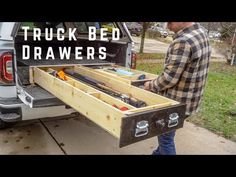 a man standing next to a truck with drawers in it's back end and the words truck bed drawers written on top