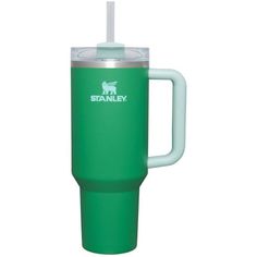 a green travel mug with a straw in the cup and logo on it that says stanley