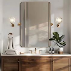 a bathroom vanity with a large mirror above it and two lights on the wall next to it