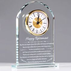 a clear glass clock with a happy retirement message on it