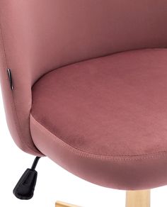 a close up of a pink chair with a wooden base