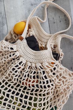 a crocheted bag with an orange in it