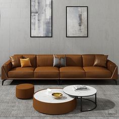 a living room with two pictures on the wall and three couches in front of it