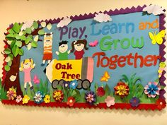 a bulletin board that says play, learn and grow together