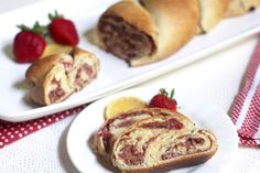 two plates with pastries and strawberries on them