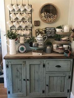 an old dresser is covered with coffee cups and mugs