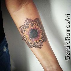 a woman's arm with a sunflower tattoo on it