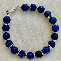 New Gorgeous Lapis Lazuli Beaded Bracelet With 925 Silver Lobster Claw Clasp. Bracelet Is 6 1/2 Inches Long. Sterling Silver Jewelry With Polished Blue Beads, Elegant Blue Bracelets With Polished Beads, Blue Sterling Silver Round Bracelets, Blue Sterling Silver Bracelets, Blue Sterling Silver Jewelry With Round Beads, Blue Sterling Silver Bracelet, Blue Sterling Silver Round Bracelet, Blue Round Sterling Silver Bracelet, Classic Blue Sterling Silver Bracelets