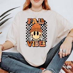 *If you would like a colour or size that is not listed, please contact us. Embrace the cozy autumn season with our Fall Vibes Shirt, designed to bring warmth and style to your wardrobe. Perfect for pumpkin spice lovers and fall enthusiasts. 🍂 Soft and Comfortable: Made from high-quality cotton for a cozy feel, ideal for layering on chilly days. 🎃 Cute Fall Design: Features a retro-inspired graphic that celebrates the beauty of fall, from pumpkins to autumn leaves. 🍁 Versatile Style: Perfect f Fall Fan Apparel T-shirt With Graphic Print, White Fall Fan Merchandise T-shirt, Sublimation Print T-shirt For Fall Streetwear, Fan Apparel Graphic T-shirt For Fall, Fan Apparel Graphic Print T-shirt For Fall, White Fan Merchandise T-shirt For Fall, Fall Graphic Tee For Fan Merchandise, Retro Fall Tops For Fan Merchandise, Retro Fan Merchandise Tops For Fall