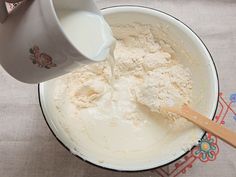 a bowl filled with flour being poured into it