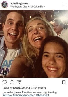 two women and a man are smiling for the camera, while one woman is taking a selfie