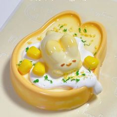 there is a small yellow dessert on the plate with corn and yogurt in it