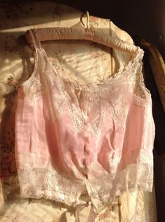 very, very beautiful pink silk and lace antique camisole 1880ssize  M/Lsoft silk fabric with delicate lace and pink silk ribbonsAlong the neck line the ribbon is a bit to short to wear in a larger size.I also saw a slightly underarm discolorationno weak era'sin excellent conditionbust  40"  or smaller  102 cm or smallerwaist  32" or smaller   82 cmlength  18"   46 cm Pink Silk Spaghetti Strap Camisole, Fitted Pink Lace Top With Lace Trim, Elegant Pink Camisole For Daywear, Sleeveless Pink Lace Top With Lace Trim, Pink Sleeveless Lace Top With Lace Trim, Feminine Pink Silk Camisole, Pink Silk Camisole For Summer, Feminine Pink Lace Top With Lace Patchwork, Pink Lace Trim Camisole With Spaghetti Straps