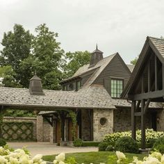 a large house with lots of flowers in the front yard