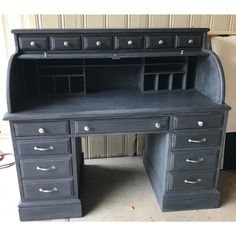 an old black desk with lots of drawers