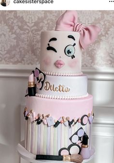 a three tiered cake decorated with pink and white icing, featuring an image of a woman's face