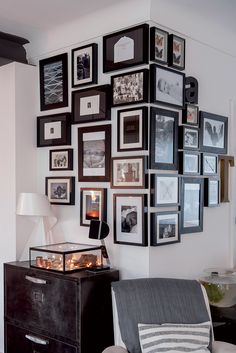 a living room with pictures on the wall