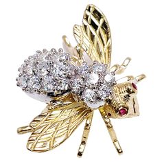 Absolutely stunning, excellent condition diamond brooch made in 18KT yelllow & white gold by Herbert Rosenthal. A rare find because this is the large version. CENTER STONE: NATURAL DIAMONDS CARAT: 1.55CT CLARITY: VS1-VS2 COLOR: F CUT: ROUND BRILLIANT OTHER GEMSTONE(S): 2 small round rubies 1.8mm GRAM WEIGHT: 9.90gr GOLD: 18KT yellow gold CLOSURE: pin MEASUREMENTS: 1.25 X 1 INCHES LONG DESIGNER: Herbert Rosenthal WHAT YOU GET AT STAMPAR JEWELERS: Stampar Jewelers, located in the heart of Jupiter, Florida, is a custom jewelry store and studio dedicated to providing 100% satisfaction to each client. Our personal attention to detail, passion, affordability and honesty set us apart from any other store. We will bring full catering of our services to you online through phone calls, consultations Bee Pin, Diamond Brooch, In 3d, Jewelry Stores, Custom Jewelry, Brooch Pin, Natural Diamonds, Ruby, Crown Jewelry