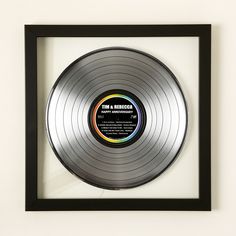 a silver record in a black frame on the wall