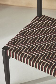 a close up of a chair with a pattern on the seat and backrests