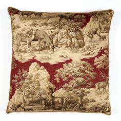 a red and beige pillow with animals on it